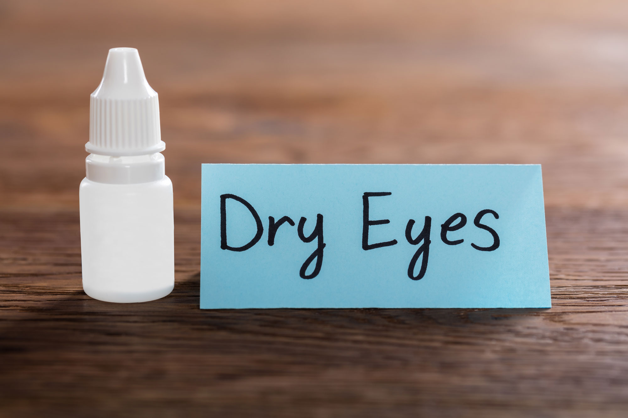 eye drops next to sign that says dry eyes